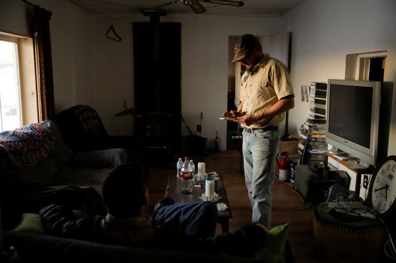 Kacey Dawson stands inside the living room of a survival camp