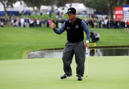 K.J. Choi reacts after he makes his putt on the eighteenth hole green during the third round of the Farmers Insurance Open golf tournament at Torrey Pines Municipal Golf Course - South Course. Gary A. Vasquez-USA TODAY Sports