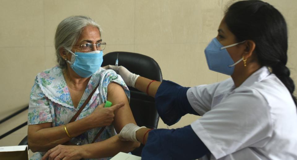 A woman above the age of 45 being vaccinated against COVID-19 at a district hospital in Noida, India. Photo: Sunil Ghosh/Hindustan Times via Getty Images
