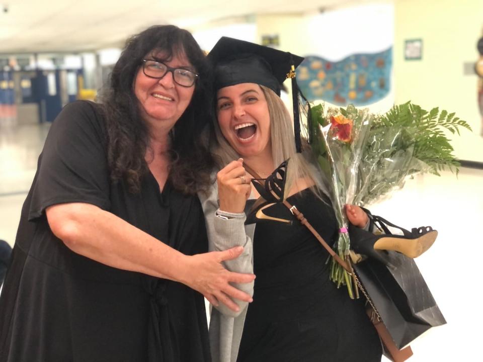 Afroditi Marinakis and her mother Arsenia Varsamis celebrate following Marinakis' graduation ceremony. The 33-year-old earned her high school diploma through adult education at CDC Vimont in Laval. (Ainslie MacLellan/CBC - image credit)