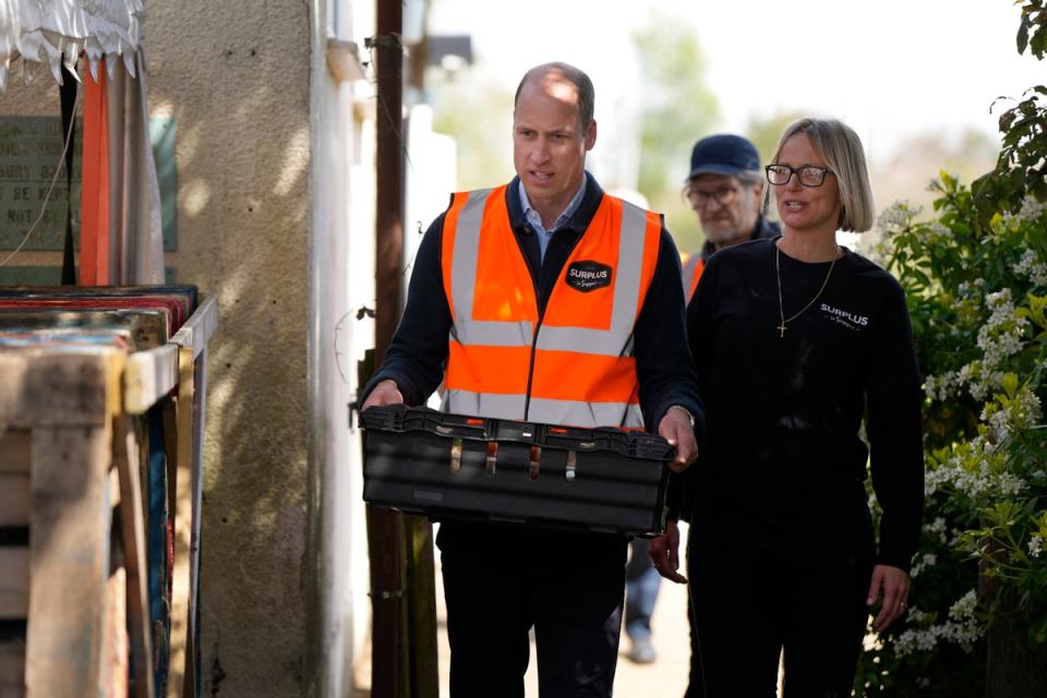 Prince William carries a tray of food items with Claire Hopkins, Operations Director (AP)