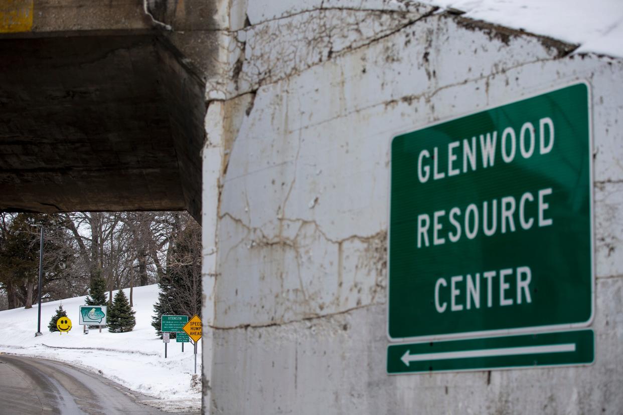 Signs mark the entrance to the Glenwood Resource Center, one of two state facilities in Iowa providing care for people with profound intellectual disabilities. The state is closing the center by the end of June 2024.