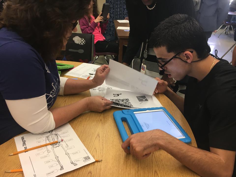 Wellington High School paraprofessional Donna Rice assists sophomore Eduardo Tapia with an assignment on his iPad in Wellington. Paraprofessionals work with students of all ages who have special needs or individualized education plans.