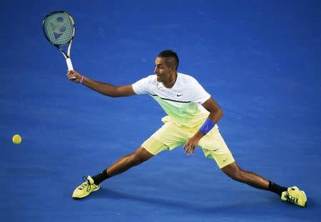 Nick Kyrgios of Australia stretches to hit a return against Andy Murray of Britain during their men's singles quarter-final match at the Australian Open 2015 tennis tournament in Melbourne January 27, 2015. REUTERS/Carlos Barria