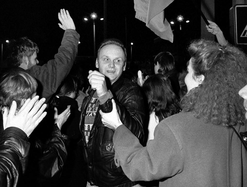 West Berliners welcome an East Berlin citizen crossing the border at the Allied checkpoint Charlie after the opening of the East German border was announced in this Nov. 9, 1989. (Photo: Fabrizio Bensch/Reuters)