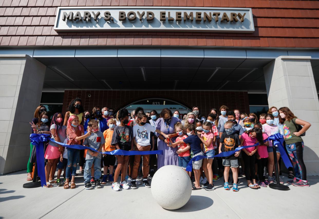 Boyd Elementary School Principal Angela Holloway-Payne, center, along with students, teachers, school board members, and others cut the ribbon for the new Boyd Elementary School on Thursday, Sep. 9, 2021.