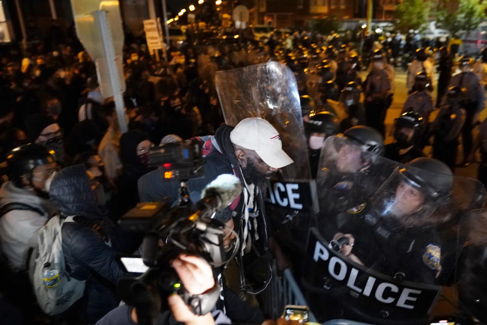 A protester confronts police during a march Tuesday Oct. 27, 2020 in Philadelphia. Hundreds of demonstrators marched in West Philadelphia over the death of Walter Wallace, a Black man who was killed by police in Philadelphia on Monday. Police shot and killed the 27-year-old on a Philadelphia street after yelling at him to drop his knife. (AP Photo/Matt Slocum)