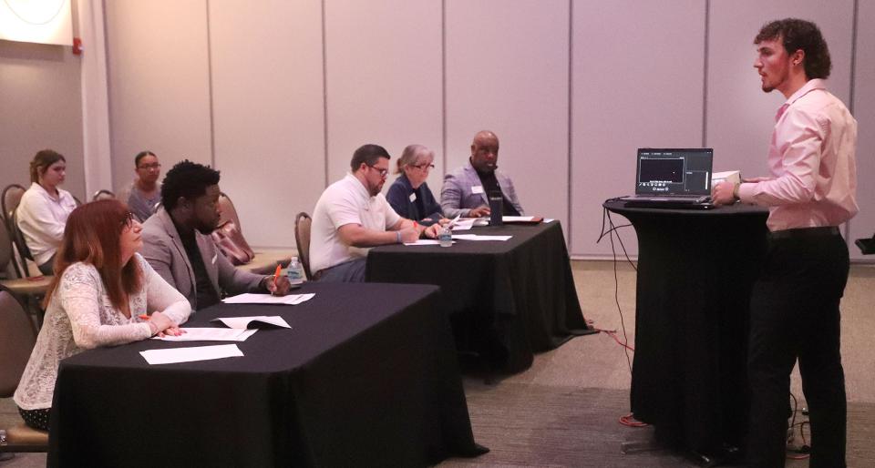 New Smyrna Beach High School student Andrew Wells pitches his idea to sell sunflower seed snacks to the judges, during the Network for Teaching Entrepreneurship second annual "Shark Tank" style pitch competition for high school students, Wednesday, March 13, 2024, at the Center in Deltona.