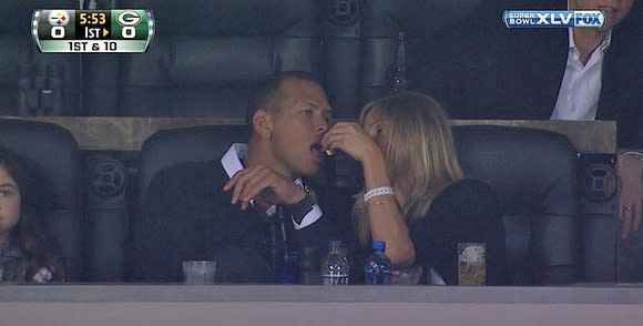 A-Rod gets popcorn fed to him at the Super Bowl. (Fox)