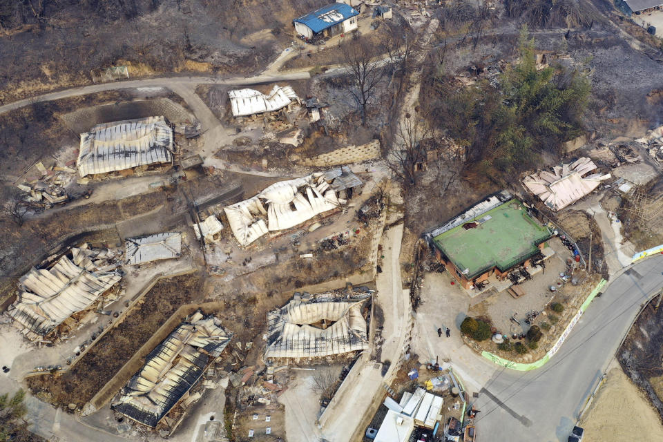 Homes damaged by a wildfire are seen in Uljin, South Korea, Saturday, March 5, 2022. South Korea was deploying nearly 2,000 firefighters and troops on Saturday to battle a large wildfire that tore through an eastern coastal area and temporarily threatened a nuclear power station and a liquified natural gas plant. (Kim Huyn-tae/Yonhap via AP)