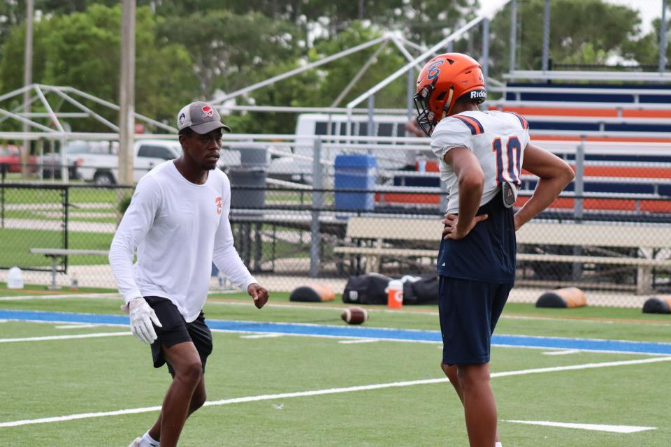 Class of 2025 student Amaree Williams works with Benjamin wide receivers coach Brandon Shedd.