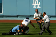 A fan who ran onto the field is taken down by security during the game between the Los Angeles Dodgers and the Colorado Rockies on opening day at Dodger Stadium on April 9, 2007 in Los Angeles, California. (Photo by Stephen Dunn/Getty Images)