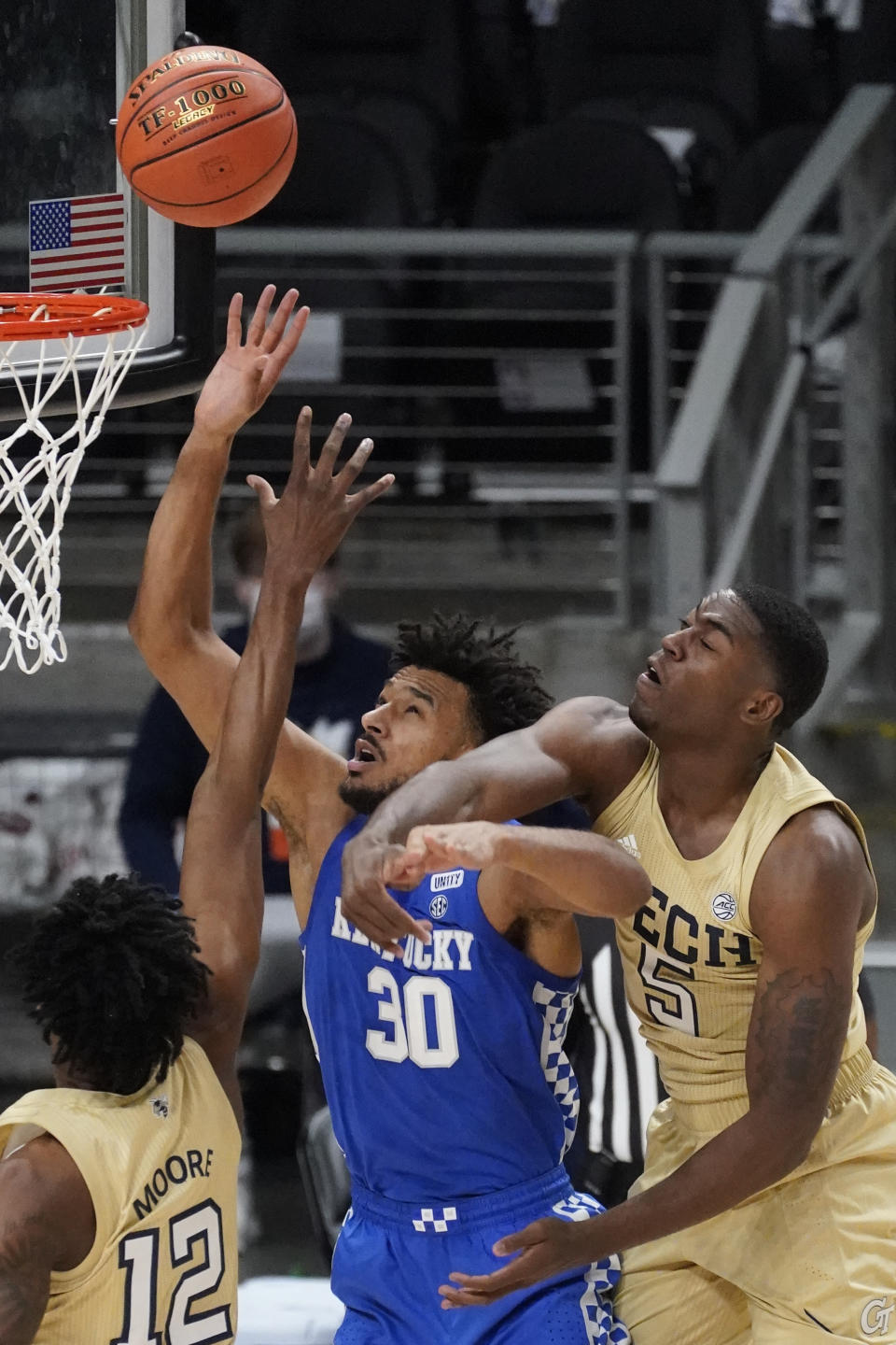 Kentucky forward Olivier Sarr (30) battled Georgia Tech forward Moses Wright (5) for a rebound during the first half of an NCAA college basketball game Sunday, Dec. 6, 2020, in Atlanta. (AP Photo/John Bazemore)