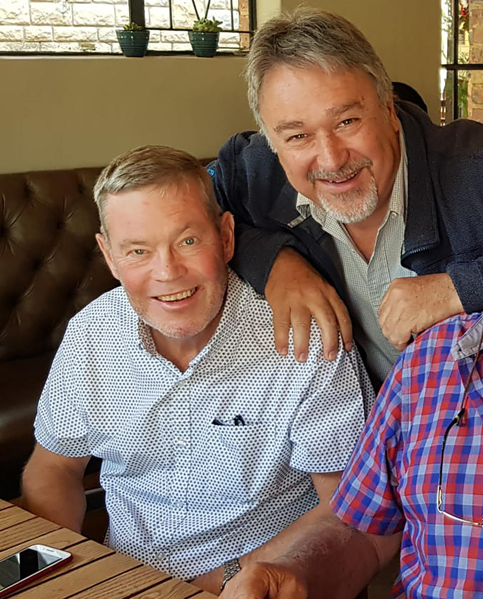 This undated photo shows South African photographer John Parkin, left, with fellow photographer Meter Morey in Pretoria, South Africa. Parkin, who covered the country's anti-apartheid struggle, its first democratic elections, and the presidency of Nelson Mandela, has died Monday Aug. 23, 2021, at the age of 63 according to his daughter. (AP Photo)