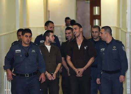 Israeli prison guards escort far-right activists Yitzhak Gabai, Nahman Twito and Shlomo Twito at Jerusalem District Court December 15, 2014. REUTERS/Ammar Awad