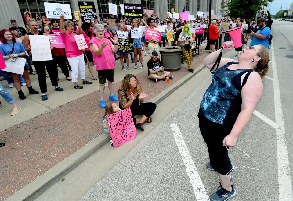 April Bracco of Springfield, right, addresses the crowd  during a rally in front of the federal courthouse in Springfield organized by the Resistor Sisterhood after the U.S. Supreme Court overturned Roe v. Wade Friday June 24, 2022