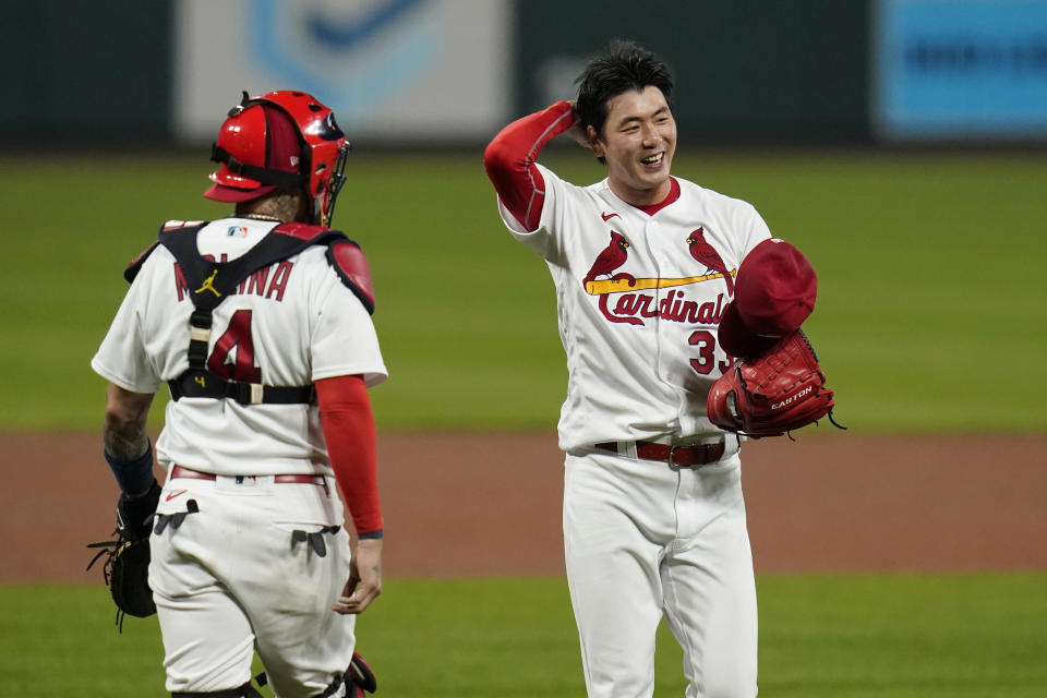 St. Louis Cardinals catcher Yadier Molina (4) walks out to the mound to talk with starting pitcher Kwang-Hyun Kim during the fifth inning of a baseball game against the Milwaukee Brewers Thursday, Sept. 24, 2020, in St. Louis. (AP Photo/Jeff Roberson)