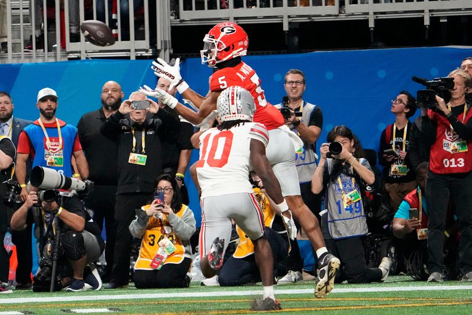 Georgia wide receiver Adonai Mitchell catches the game-winning touchdown against the defense of Ohio State cornerback Denzel Burke during the Peach Bowl at Mercedes-Benz Stadium on Dec. 31.