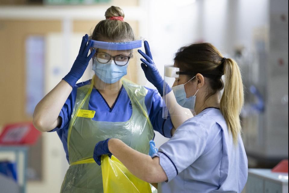 <p>Face mask deals: Covid nurses changing their PPE</p> (PA)