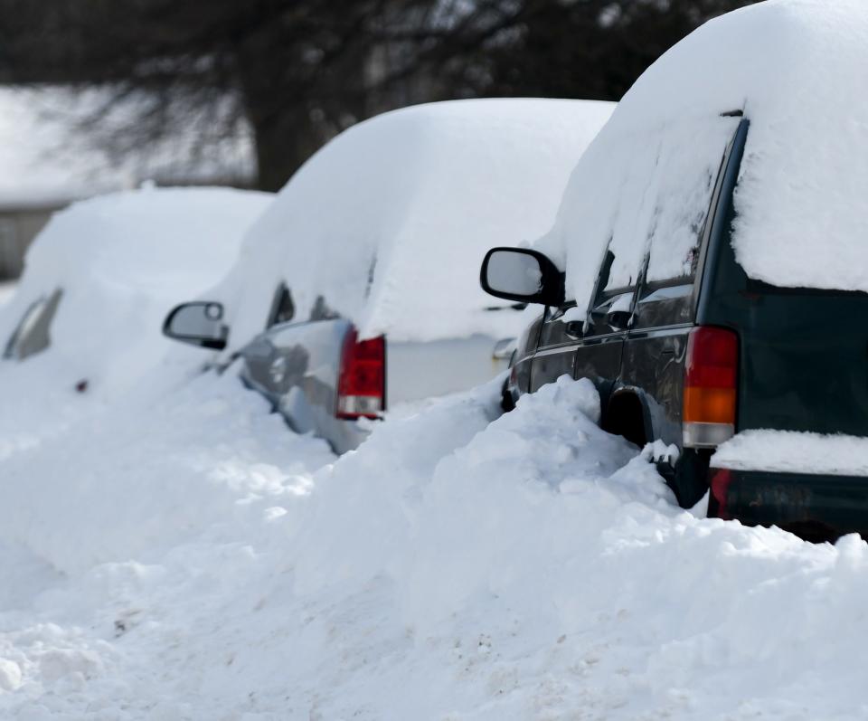 Cars buried from the pile of snow on Ansley Street in Alliance after the January storm.
