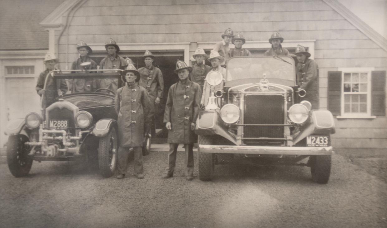 A photo from 1936 shows the original Barnstable Fire Station which is still in use as offices today facing out onto Route 6A in the village. The truck at right is still owned by the department and is used for parades.