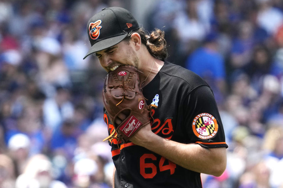 Baltimore Orioles starting pitcher Dean Kremer bites his glove while he walks back to the dugout after the fourth inning of a baseball game against the Chicago Cubs in Chicago, Sunday, June 18, 2023. (AP Photo/Nam Y. Huh)