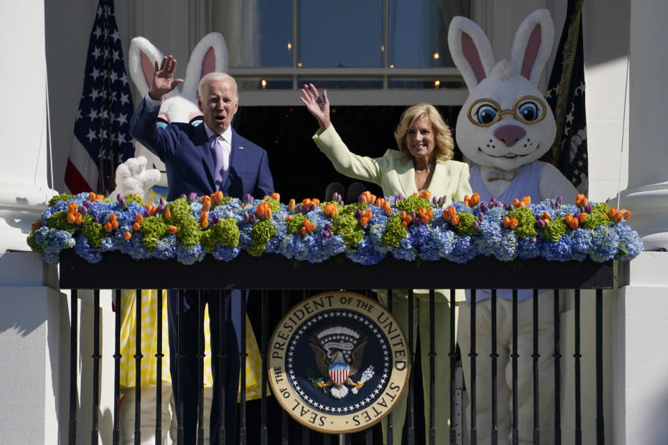 President Joe Biden and first lady Jill Biden wave from the Blue Room Balcony as they attend the 2023 White House Easter Egg Roll, Monday, April 10, 2023, in Washington. (AP Photo/Evan Vucci)