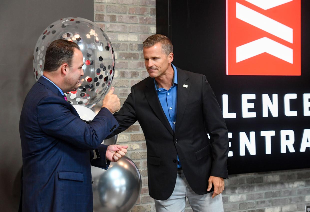 Mayor Paul TenHaken gives Brandon Maddox, CEO of Silencer Central, a Challenge Coin during a celebration of the company's place on the Inc. 5000 List of fast-growing businesses on Tuesday, August 16, 2022, in Sioux Falls.