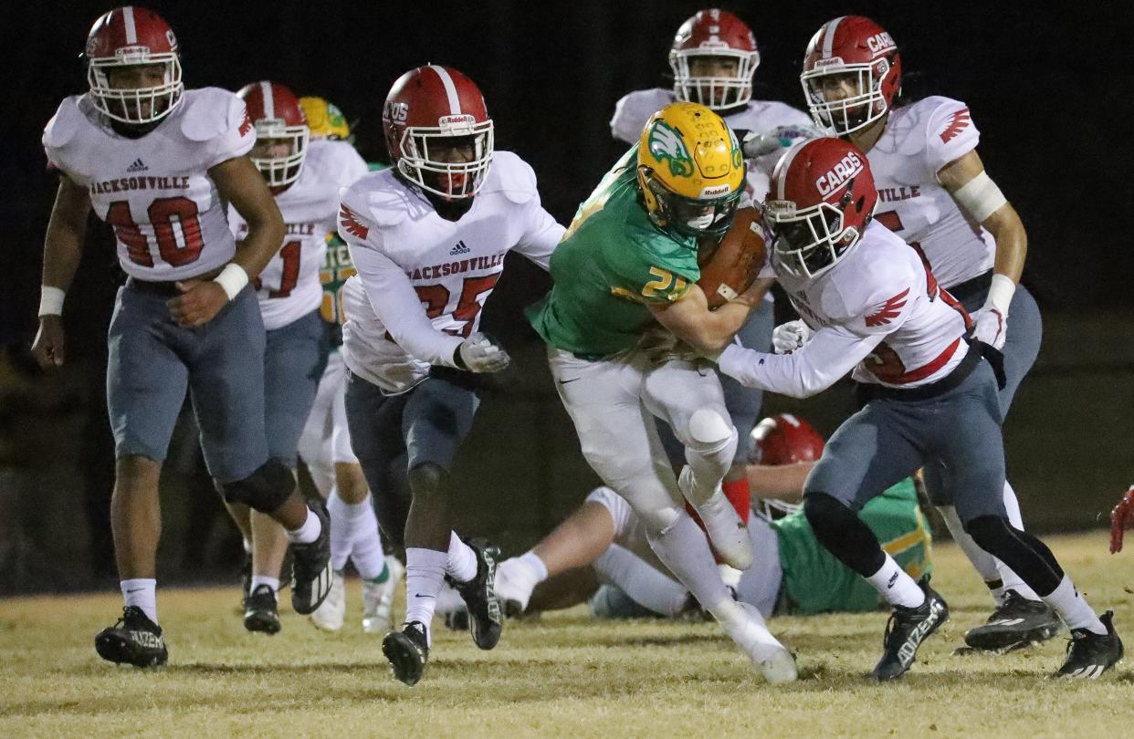 Jacksonville defenders swarm Eastern Alamance running back Joshua Murray.