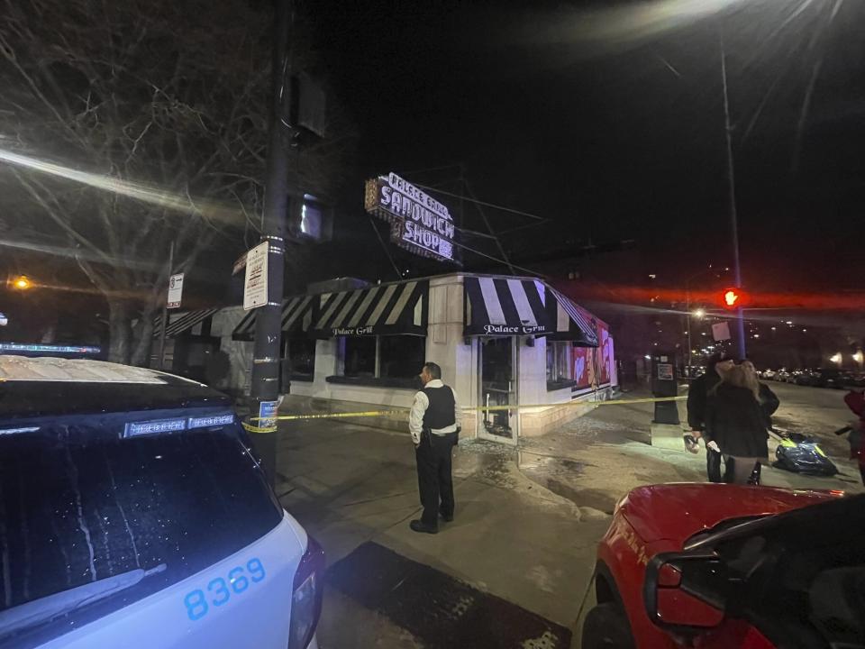 This image provided. by the Chicago Fire Dept. shows emergency responders outside the Palace Grill after an overnight fire early Friday, Feb. 9, 2024 in Chicago. The overnight fire caused extensive damage to an iconic Chicago restaurant that's known for its breakfasts and is filled with decades of memorabilia, authorities said. (Chicago Fire Dept. via AP)