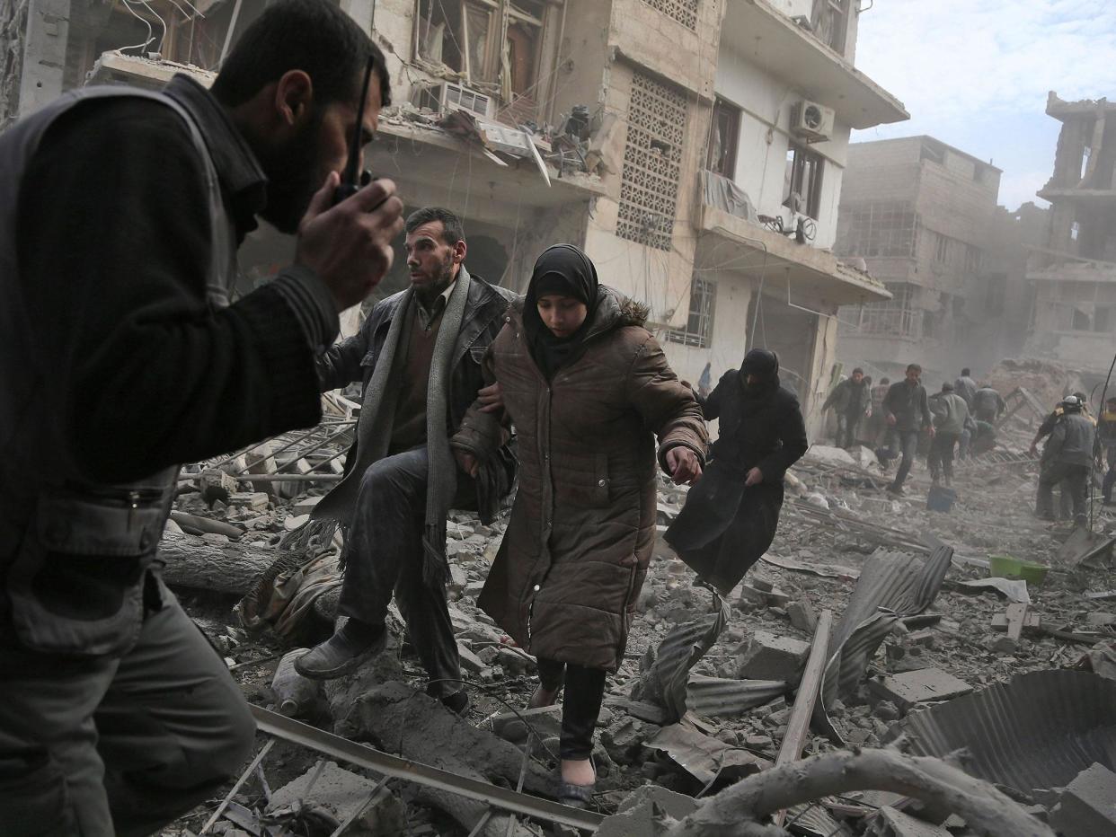 Civilians flee from an area hit by a reported regime air strike in Eastern Ghouta: AFP/Getty