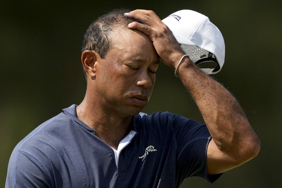 Tiger Woods wipes his face on the 10th hole during weather warnings in second round of the U.S. Open golf tournament Friday, June 14, 2024, in Pinehurst, N.C. (AP Photo/Matt York)