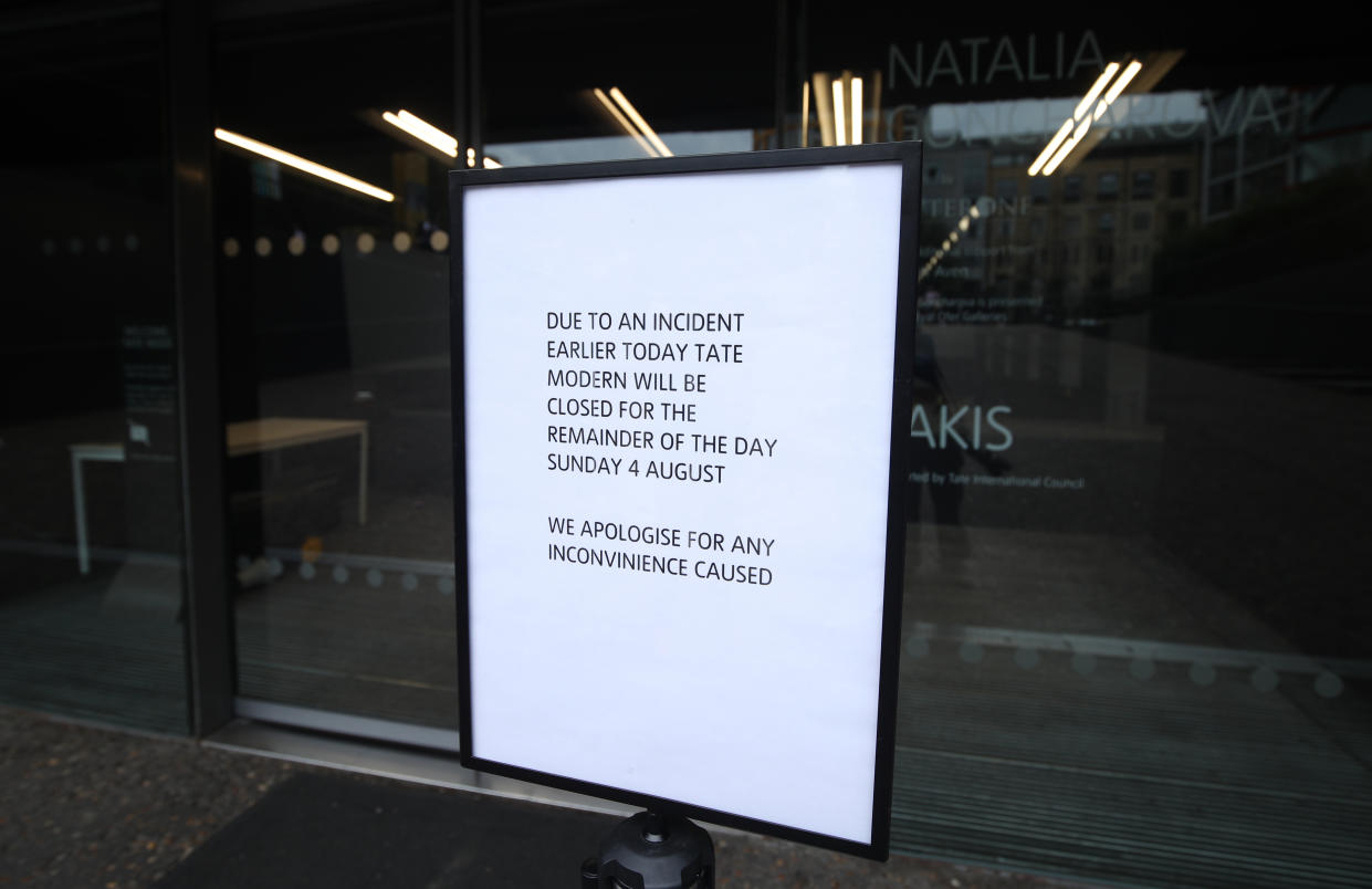 A sign posted outside of the Tate Modern reminds visitors the gallery closed earlier today due to an incident in which a teenager has been arrested after a child fell from height and was taken to hospital from the gallery in central London by air ambulance.