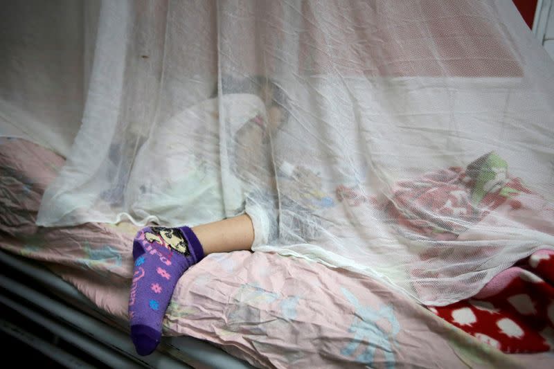 FILE PHOTO: A girl with dengue fever receives attention at Hospital Escuela in Tegucigalpa