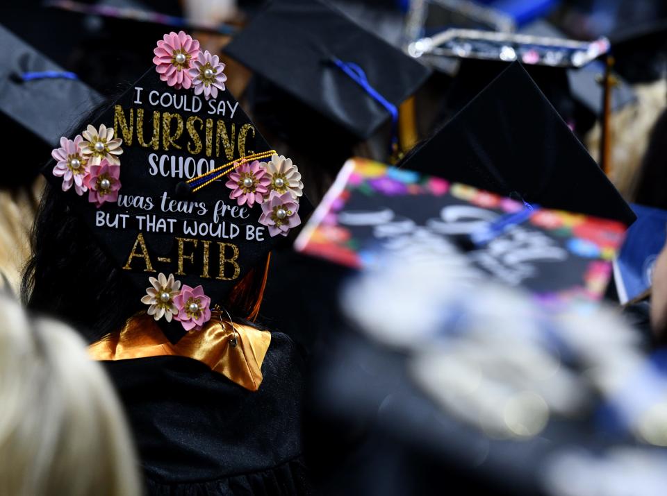 A. new nurse displays cap pride during Quinsigamond Community College commencement exercises at the DCU Center on Friday.