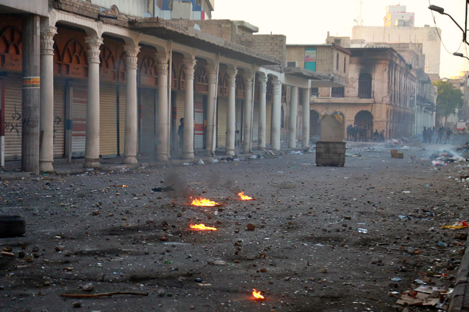 Riot police close Rasheed Street during clashes between Iraqi security forces and anti-Government protesters, in Baghdad, Iraq, Thursday, Nov. 21, 2019. Iraqi officials said several protesters were killed as heavy clashes erupt in central Baghdad. (AP Photo/Khalid Mohammed)