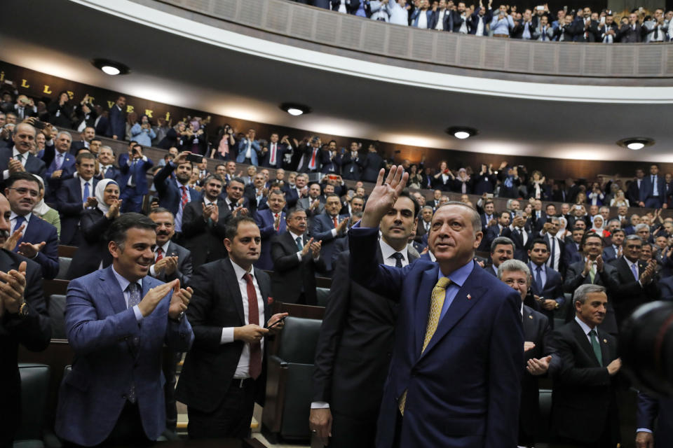 FILE - Turkey's President Recep Tayyip Erdogan waves to members of the ruling Justice and Development party (AKP) as he arrives to address them in Ankara, Turkey, on May 30, 2017. The 69-year-old who has served as prime minister since 2003 and president since 2014, started his career as a reformist who expanded rights and freedoms, allowing his majority-Muslim country to start European Union membership negotiations. (AP Photo/Burhan Ozbilici, File)