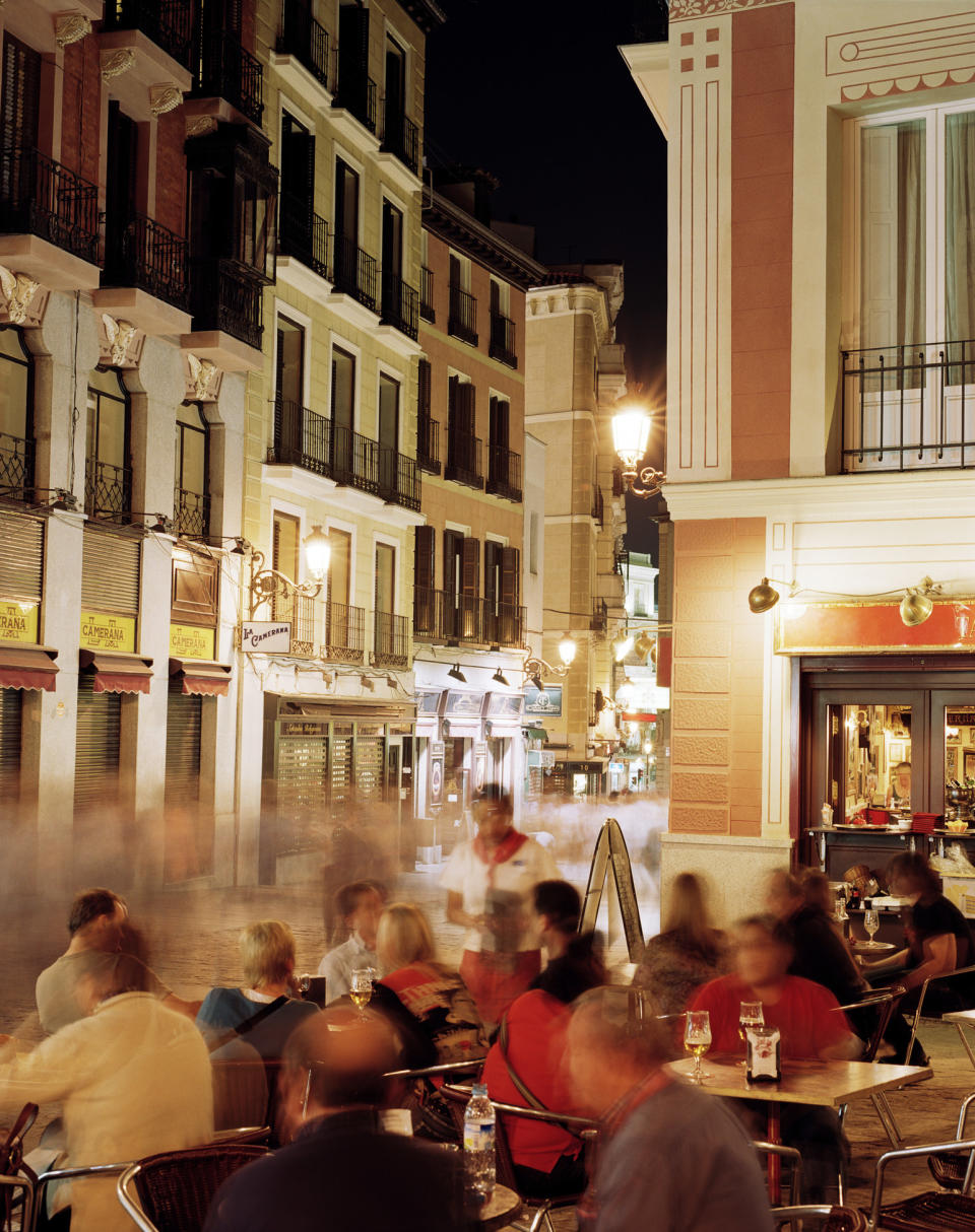 People eating outdoors at night.