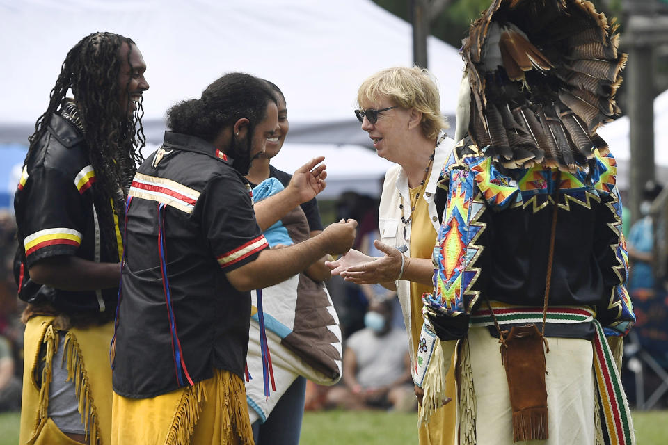 Connecticut State Sen. Cathy Osten, D-Sprauge, receives a necklace as a gift from representatives of the Pequot Nation for her support of Native Americans at Schemitzun on the Mashantucket Pequot Reservation in Mashantucket, Conn., Saturday, Aug. 28, 2021. Osten proposed a bill to add Native American studies to school social studies curriculums. (AP Photo/Jessica Hill)