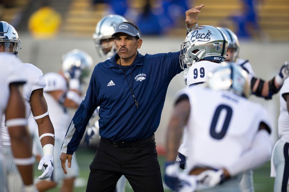Nevada coach Jay Norvell talks to players before an NCAA college football game against California, Saturday, Sept. 4, 2021, in Berkeley, Calif. (AP Photo/D. Ross Cameron)