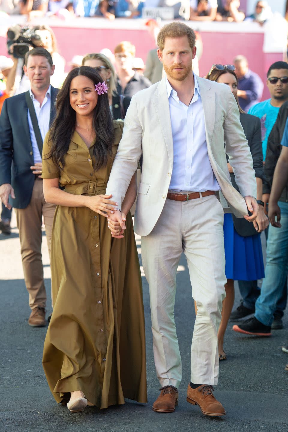 <p>Meghan held Prince Harry's hand tightly at they walked through the Bo Kaap district of Cape Town, during the royal tour of South Africa on 24 September. </p>