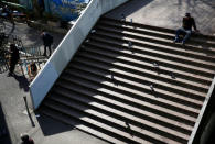 Homeless Makoto Shinbo sits on a stair nearby his makeshift house in Miyashita park in Tokyo, Japan, February 17, 2017. REUTERS/Kim Kyung-Hoon