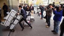 Television crews (R) film people entering the building in Sydney on May 25, 2015 where an inquest into the deaths arising from the Lindt Café siege is being held