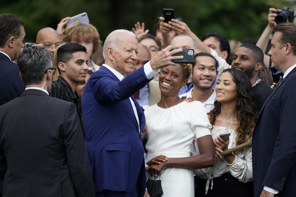 President Joe Biden poses for a photo with attendees during an Independence Day celebration on the South Lawn of the White House, Sunday, July 4, 2021, in Washington. (AP Photo/Patrick Semansky)
