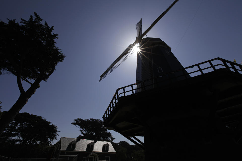 In this photo taken Thursday, May 24, 2012, the sun peeks through the Murphy Windmill in Golden Gate Park in San Francisco. (AP Photo/Eric Risberg)