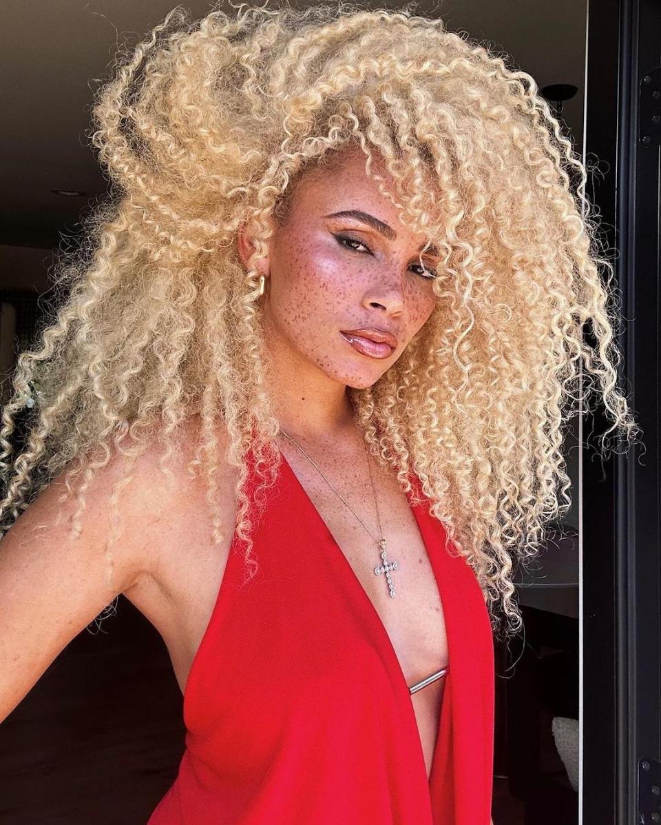 A woman with a full head of blonde curls.