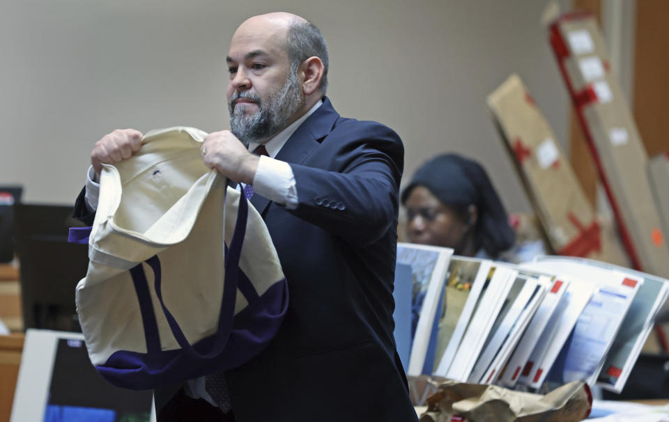 Senior Assistant New Hampshire Attorney General Benjamin Agati shows the jury a bag that the prosecution claims was used by Adam Montgomery to store his dead daughter's body during closing argument in Montgomery's trial, Wednesday, Feb. 21, 2024, in Manchester, N.H. Montgomery is accused of killing his 5-year-old daughter Harmony. (Jim Davis/The Boston Globe via AP, Pool)