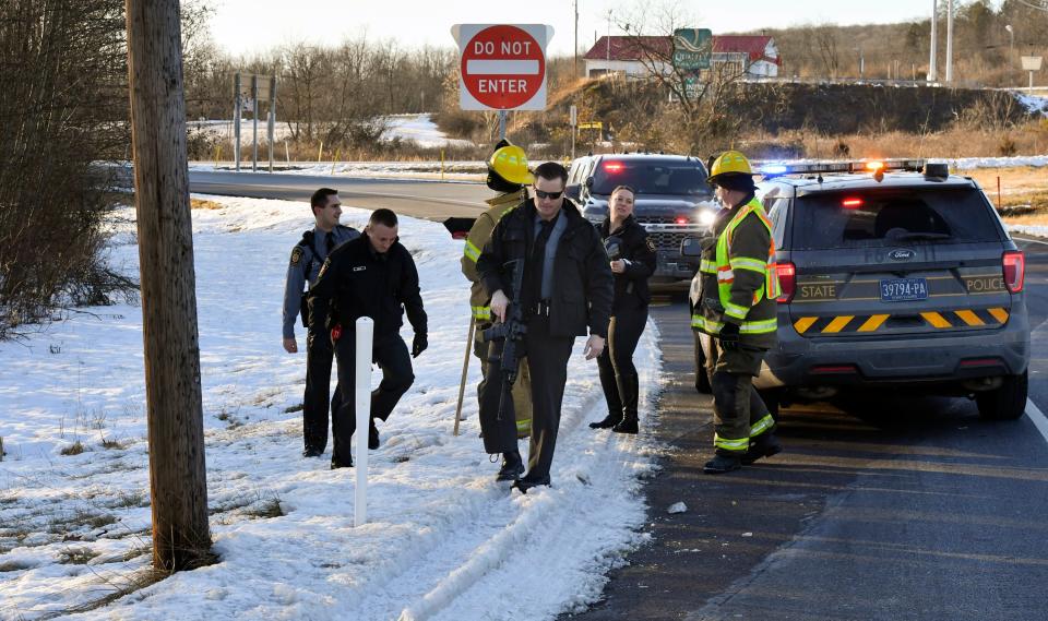 Game Commission Officers pull up as Pennsylvania State Troopers prepare to look for several monkeys which escaped from their crates after the trailer which they were being transported in was involved in a crash.