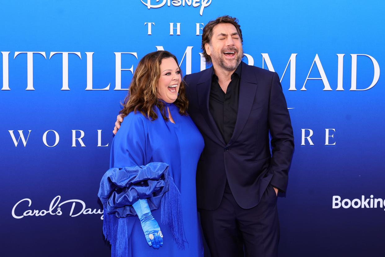 Melissa McCarthy and Javier Bardem smiling and laughing