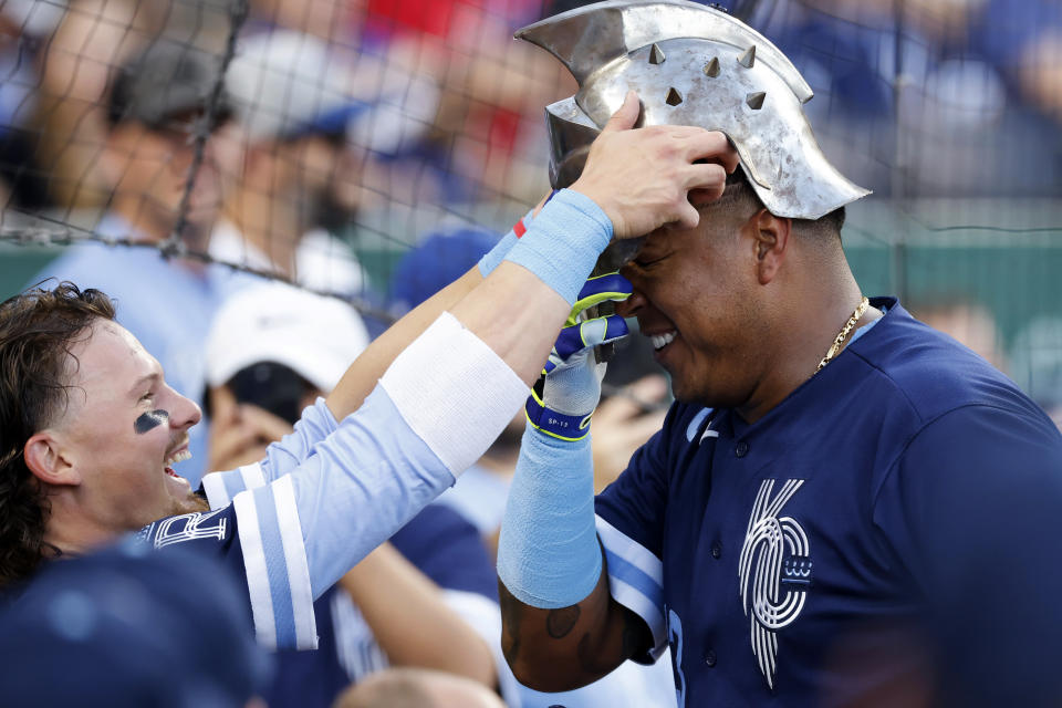Kansas City Royals' Bobby Witt Jr., left, and Salvador Perez, right, celebrate as Perez enters the dugout after hitting a home run against the Boston Red Sox during the first inning of a baseball game in Kansas City, Mo., Friday, Sept. 1, 2023. (AP Photo/Colin E. Braley)